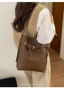 Brown litchi texture bucket bag detail showing the silver buckle and retro strap design