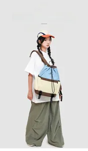 Detail of multi-color drawstring backpack featuring adjustable black buckles and nylon fabric