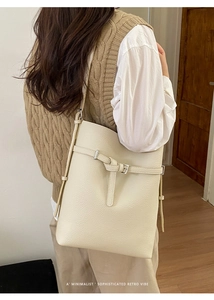 Detailed back view of a minimalist cream shoulder bag featuring pebbled leather texture
