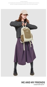Close-up of beige and brown oxford backpack with brand logo on side pocket