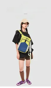 Detail of yellow and blue hiking backpack with crinkled texture and adjustable strap