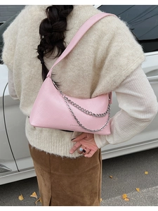 Detailed close-up of a pink matte leather hobo bag with stylish silver chain straps
