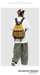Detail of a color-block drawstring backpack in ginger and brown on a model's back