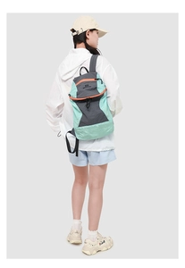 Detail of mint green and charcoal grey hiking backpack with ripstop fabric texture