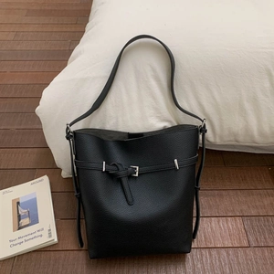Detailed view of black lychee grain leather bucket bag with silver metal buckle and strap