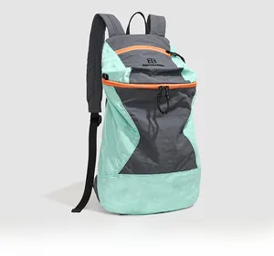 Detail view of mint green hiking backpack with tear-resistant nylon and orange zippers