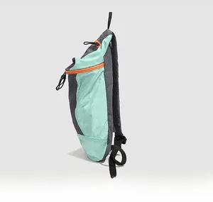Side view of outdoor backpack in mint green and grey with vibrant orange zippers