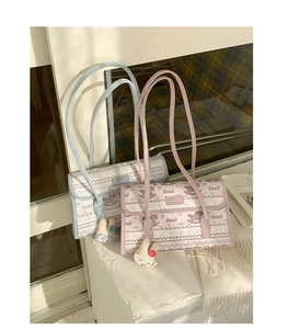 Detail of vintage cartoon tote bags with horse print, metal logo, and rabbit plush pendant