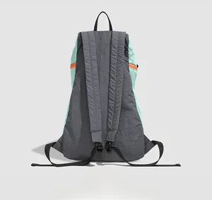 Detailed back view of a lightweight outdoor backpack in grey and mint green nylon