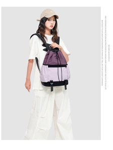 Detail view of double-layer purple drawstring backpack with bottom storage compartment