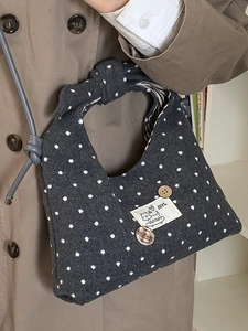 Chic charcoal grey polka dot felt handbag with a twisted handle and decorative patches