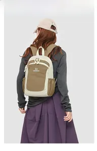 Rear view of a model wearing the minimalist two-tone outdoor travel backpack in beige