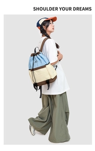 Detail shot of a casual drawstring backpack in blue, beige, and brown colors with durable fabric