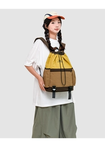 Outdoor drawstring backpack in yellow and brown patchwork with adjustable buckle straps