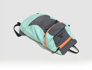 Detail of tear-resistant nylon hiking backpack with mint green and orange zipper accents