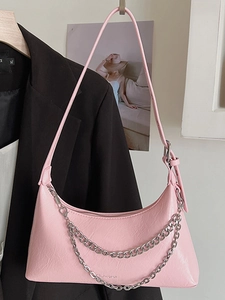 Pink crinkled patent leather crescent shoulder bag with silver chains and brand lettering