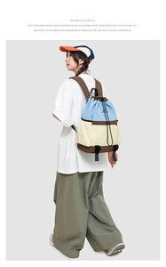 Detail view of contrast color drawstring backpack showing dual-layer storage design