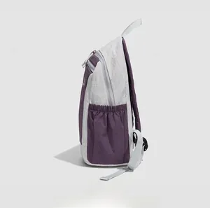 Side view of two-tone lightweight nylon backpack showing the elastic water bottle pocket