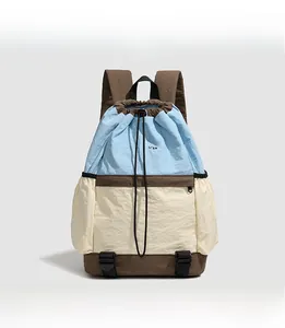 Close-up of tricolor drawstring backpack showing stitching, straps and drawstring closure