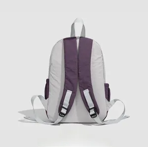 Detailed rear view of the lightweight grey nylon backpack with purple ergonomic straps