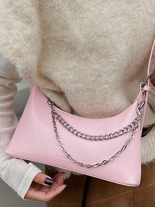 Pink crescent crossbody bag in pebbled faux leather with double silver chains