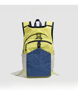 Detailed front view of contrast-color nylon backpack in yellow and navy for hiking