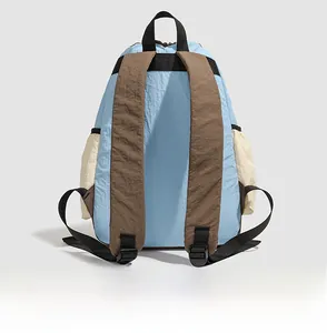 Detail view of the backpack back structure showing brown straps and blue nylon fabric