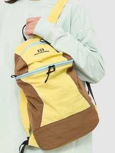 Outdoor hiking backpack with yellow and brown patchwork and blue zipper details
