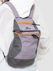 Hiking backpack in purple and grey with yellow zippers and Northnansen logo