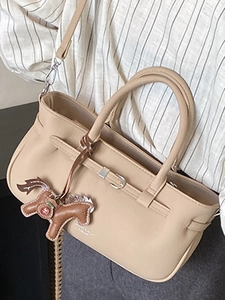 Minimalist beige crossbody bag with litchi texture, double handles and horse charm