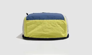 Detailed bottom view of large capacity outdoor backpack with reinforced blue stitching