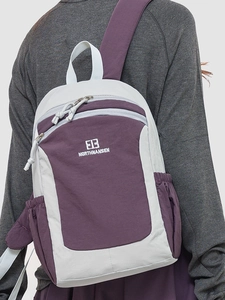 Outdoor travel backpack in purple and grey color block design with side pockets