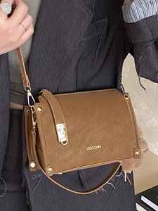 Brown suede square crossbody bag with gold logo and cute plush bear charm detail