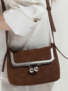 Dark brown suede mini crossbody bag with silver U-shaped metal trim and chain strap