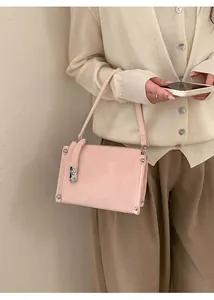Detail of pink faux leather bag with silver metallic turn-lock and rivet decorations
