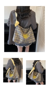 Detail of yellow and gray plaid tote bag with heart embroidery and knotted leather strap
