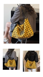 Detail of yellow checkered tote bag showing leather strap and black heart patch with Nono Life text