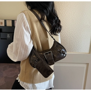 Detailed view of deep brown gloss shoulder bag with buckle and detachable pouch