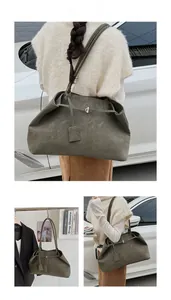 Détail d'un grand cabas en daim vert olive avec cordon décoratif et boucle en métal