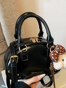 Vintage black shiny leather boston bag with golden hardware and cute bear charm