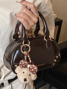 Retro dark brown patent leather handbag with gold zipper and cute plush dog charm