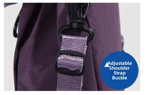 Detail view of purple nylon backpack with black plastic swivel hook and adjustable strap