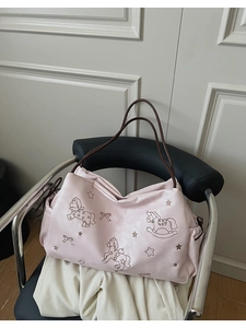 Detail of pink tote bag featuring exquisite rocking horse and bow embroidery on PU leather