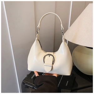 Vue détaillée du sac hobo crème avec boucle argentée sur un fond minimaliste chic