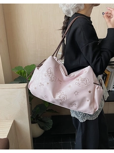 Detail of light pink leather tote bag featuring elegant horse and star embroidery