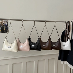 Detailed display of vintage hobo underarm bags in six colors with silver buckles