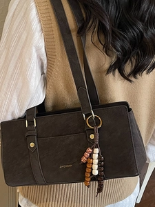 Retro dark brown underarm bag with gold logo and ethnic style wooden bead charm accessory