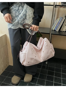 Detail of pink tote bag with horse embroidery and comfortable brown handles