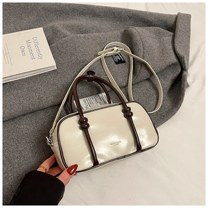 Détail du sac Boston crème avec poignées marron et logo MAOJI sur cuir synthétique