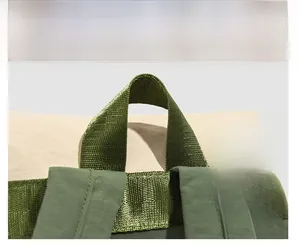 Detailed macro view of reinforced handle and premium stitching on nylon backpack